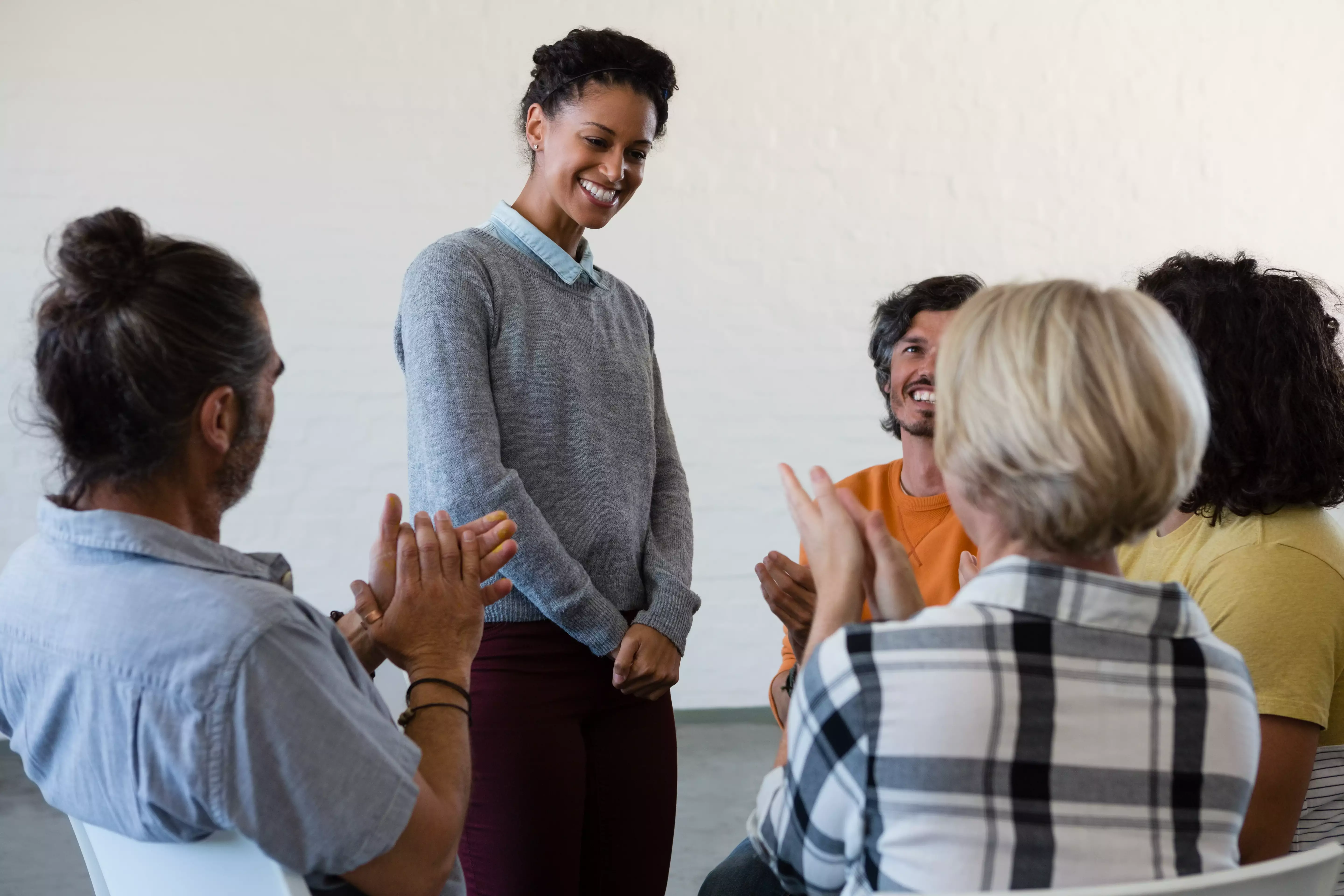 A diverse team in genuine conversation around an informal table — team cohesion in practice